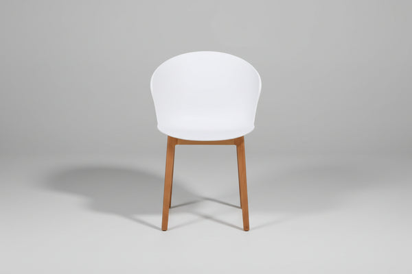 White chair with wooden legs on a white background