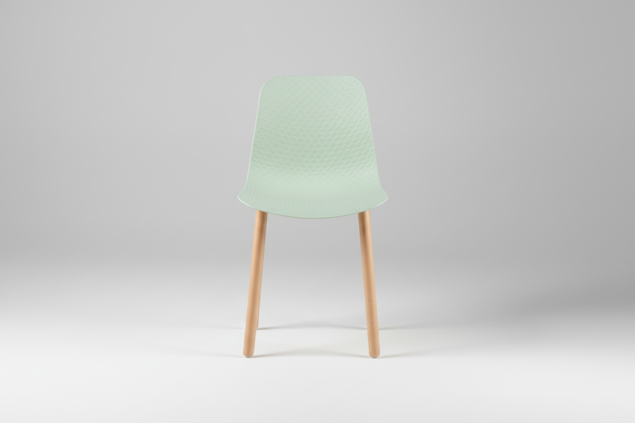 Green chair with wooden legs on a white background