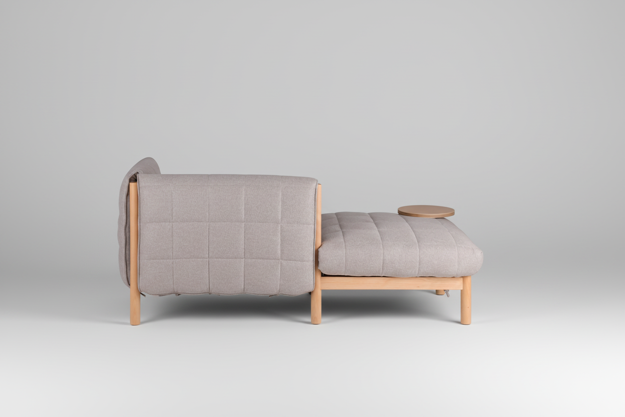 Gray upholstered chair with wooden legs and armrests on a white background