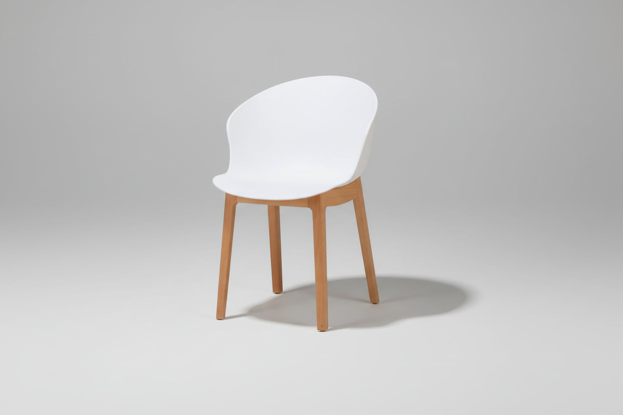 White chair with wooden legs on a white background