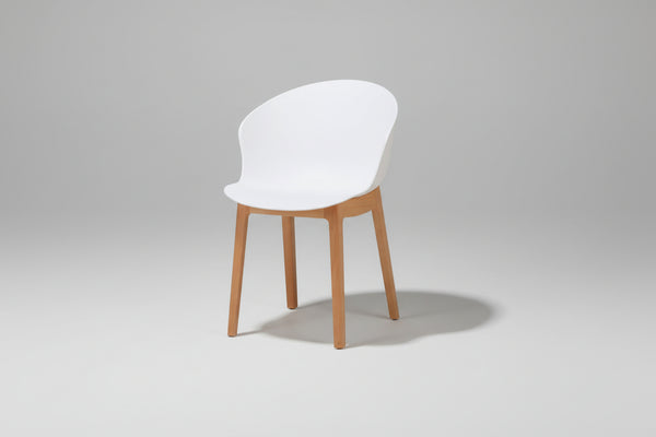 White chair with wooden legs on a white background