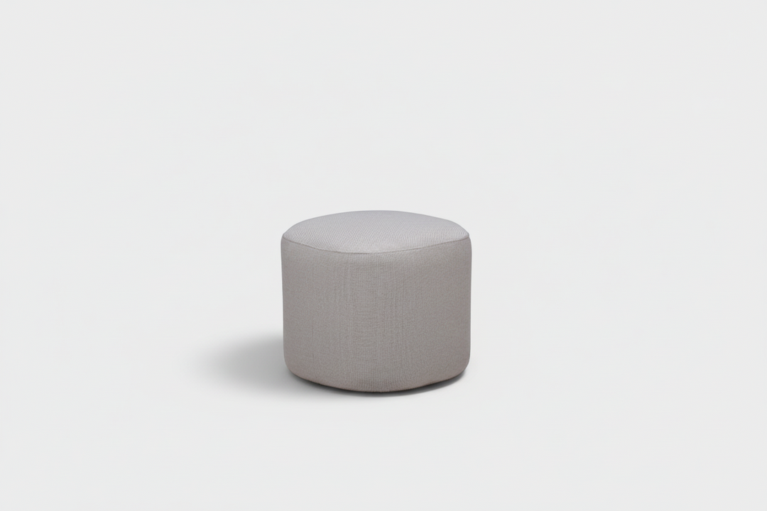 Round gray ottoman on a white background