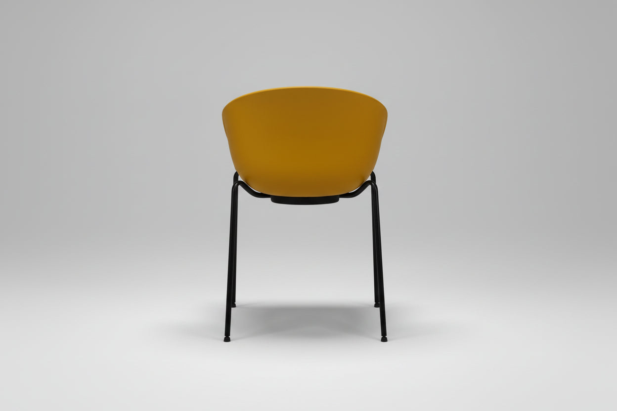 Chair with mustard yellow seat and black metal frame on a white background