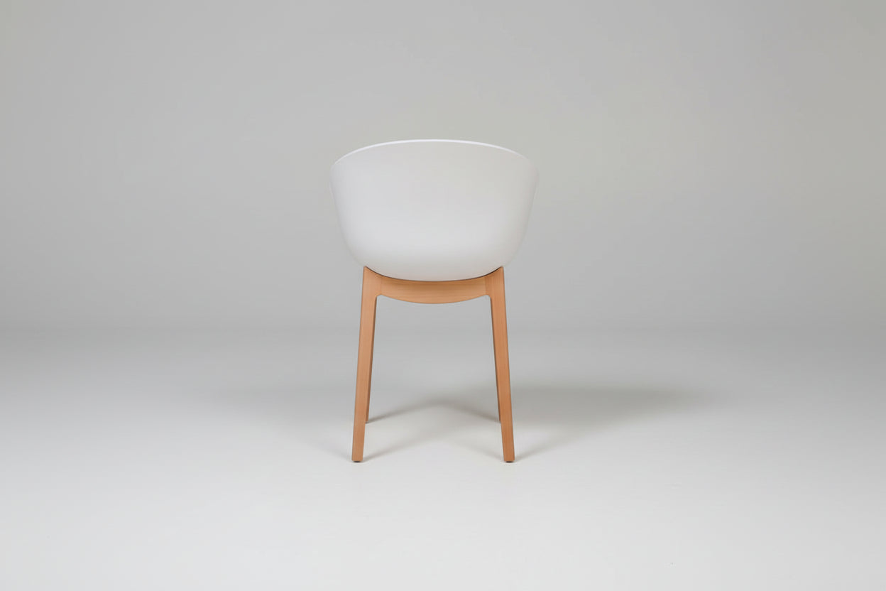 Chair with a white cushioned seat and wooden legs on a white background