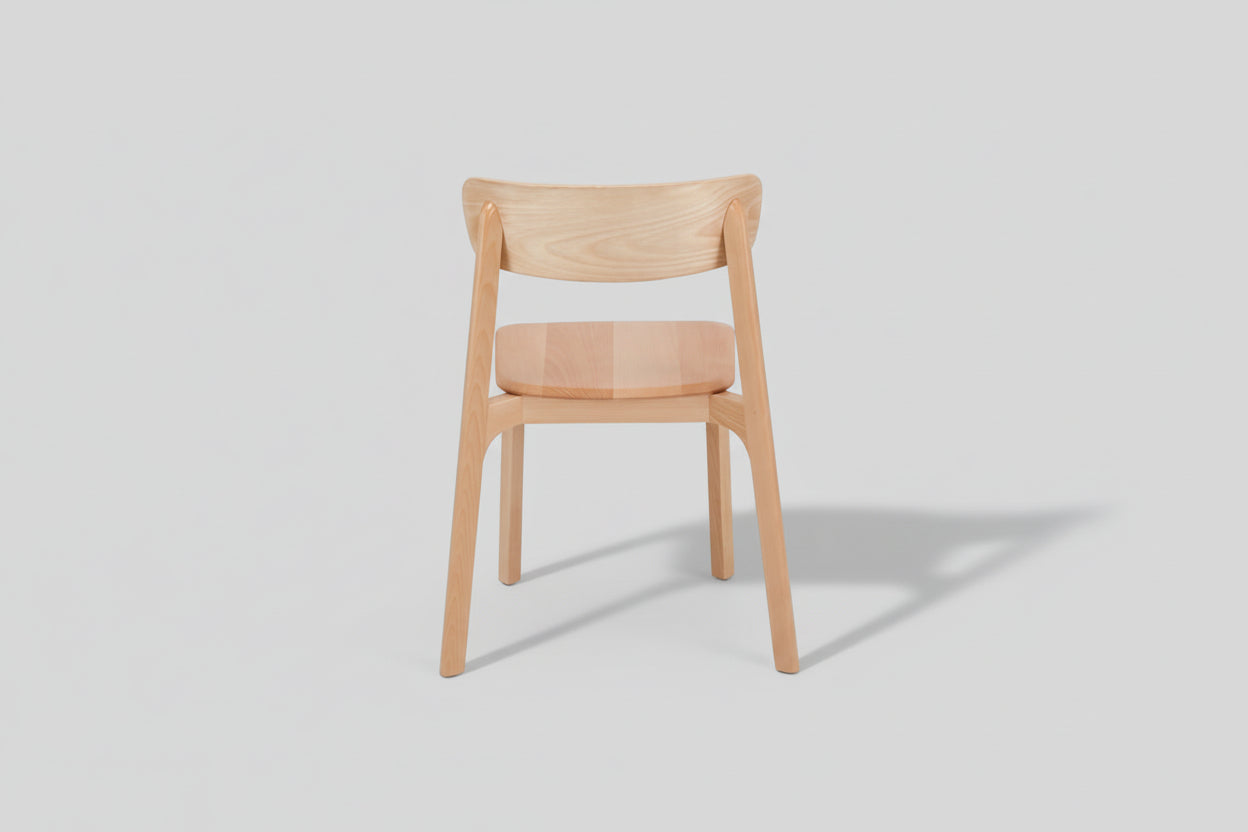 Wooden chair with a cushioned seat on a white background