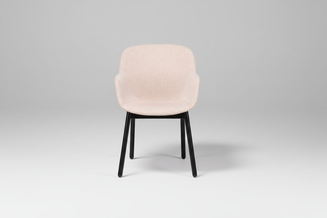 Chair with beige cushioned seat and black legs on a white background