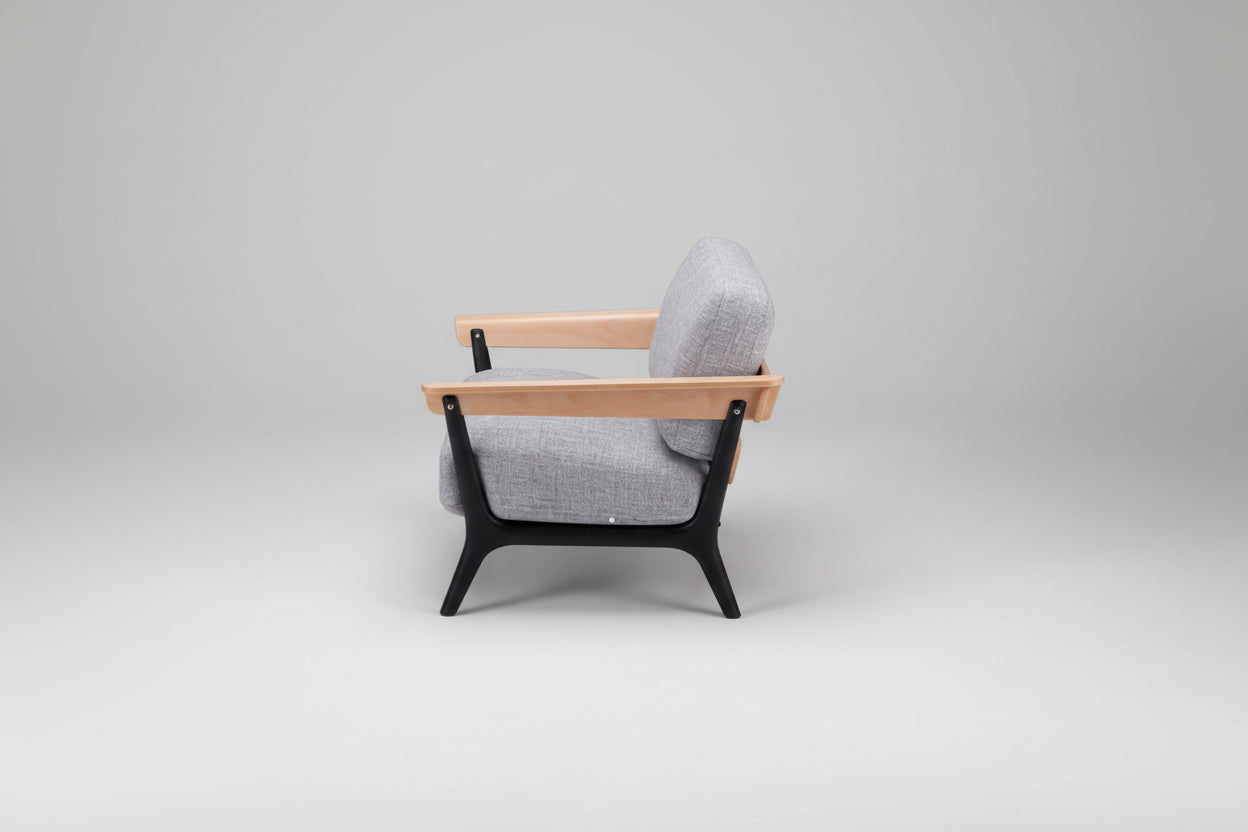 Gray armchair with wooden armrests and black legs on a white background