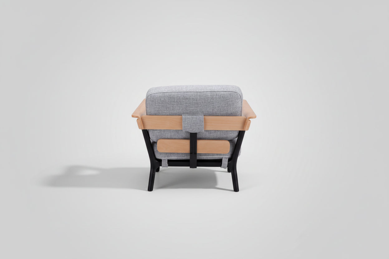Chair with gray cushioned backrest and wooden armrests on a white background